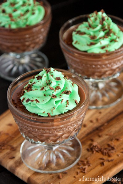 glass dishes of chocolate pudding topped with mint buttercream