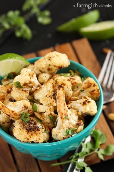 a blue bowl of Roasted Cauliflower with fresh lime