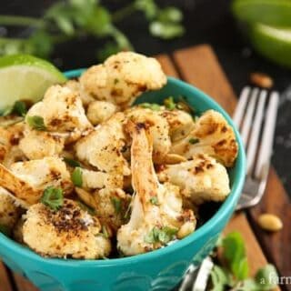 Roasted Cauliflower with Pepitas in a blue serving bowl