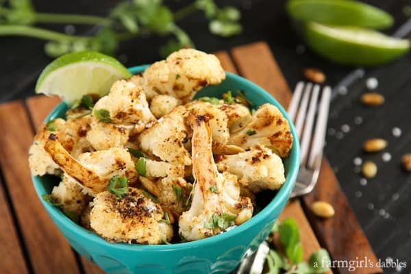 Roasted Cauliflower with Pepitas in a blue serving bowl