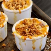 a white ramekin filled with baked Macaroni and Cheese