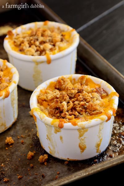 a white ramekin filled with baked Macaroni and Cheese