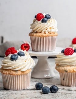 Angel food cupcake on stand, with other cupcakes on counter