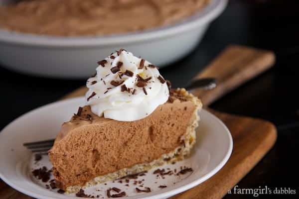 Side view of a slice of French Silk Pie on a white plate