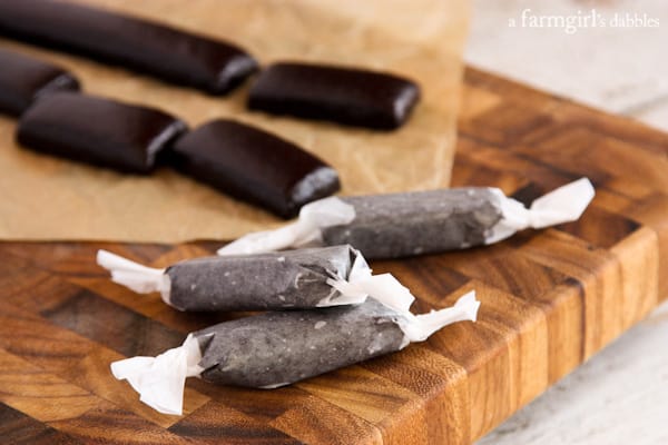 Black Licorice Caramels on a wood cutting board