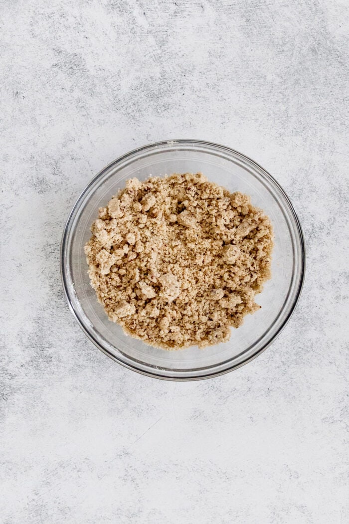 This lighter-than-air French silk pie recipe with 2 types of chocolate, espresso, and a salted pecan crust is a decadent holiday treat. Crumbly salted pecan crust mixture in a bowl.