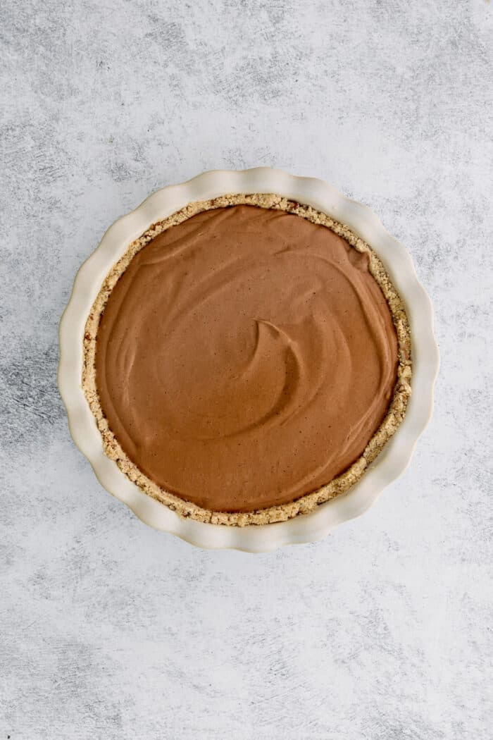 Adding the filling to the baked crust.