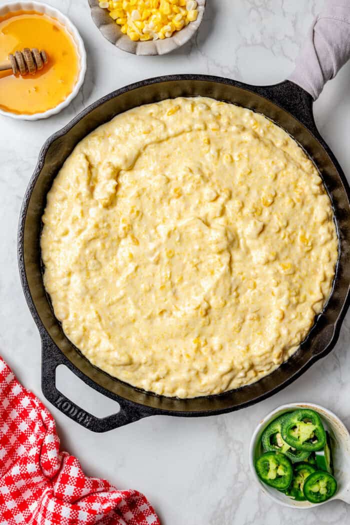 Raw corn casserole batter in the skillet. 