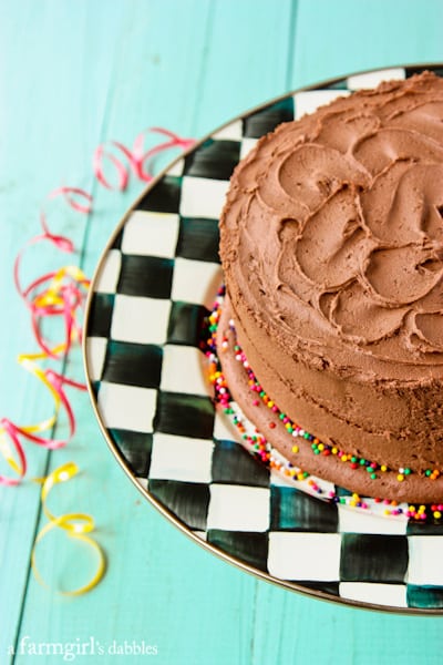 a chocolate cake on a checkered cake stand