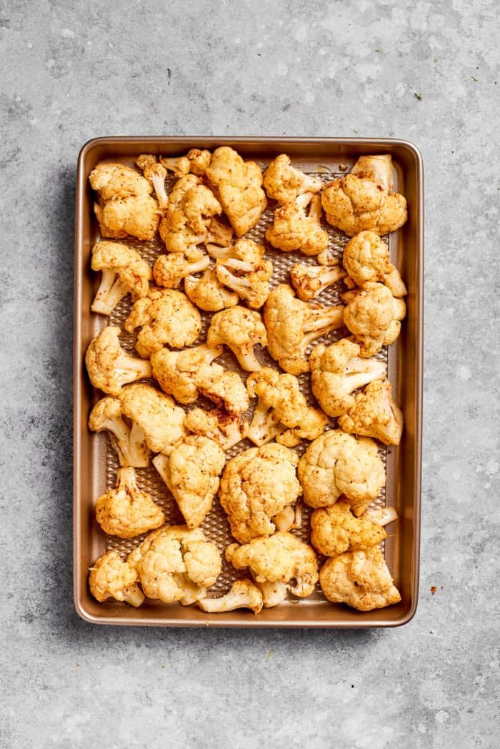 Seasoned roasted cauliflower on pan.