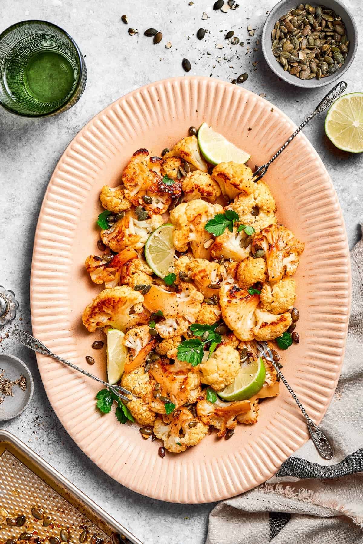 Serving plate with Mexican roasted cauliflower and peptias.