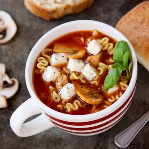 a white mug of chicken lasagna soup