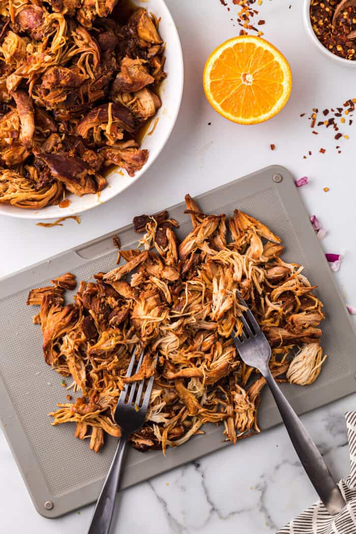 Shredded chicken on a cutting board