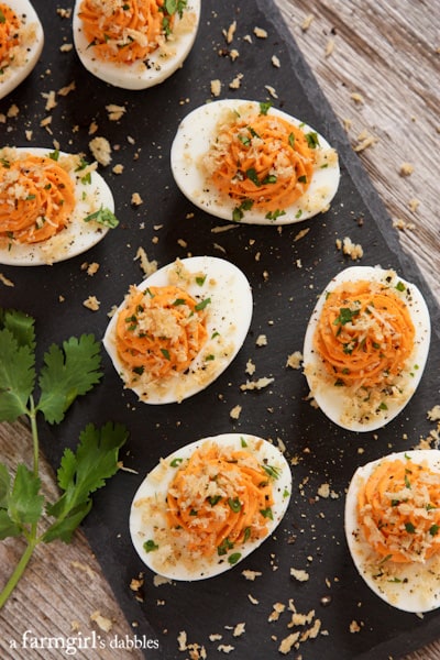 deviled eggs with sriracha filling and fresh cilantro