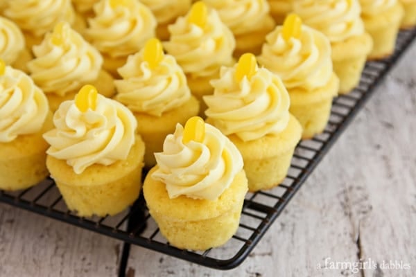 lemon cupcakes topped with frosting and a lemon jelly bean