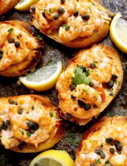 Overhead view of sriracha garlic toast with shrimp on a gray plate