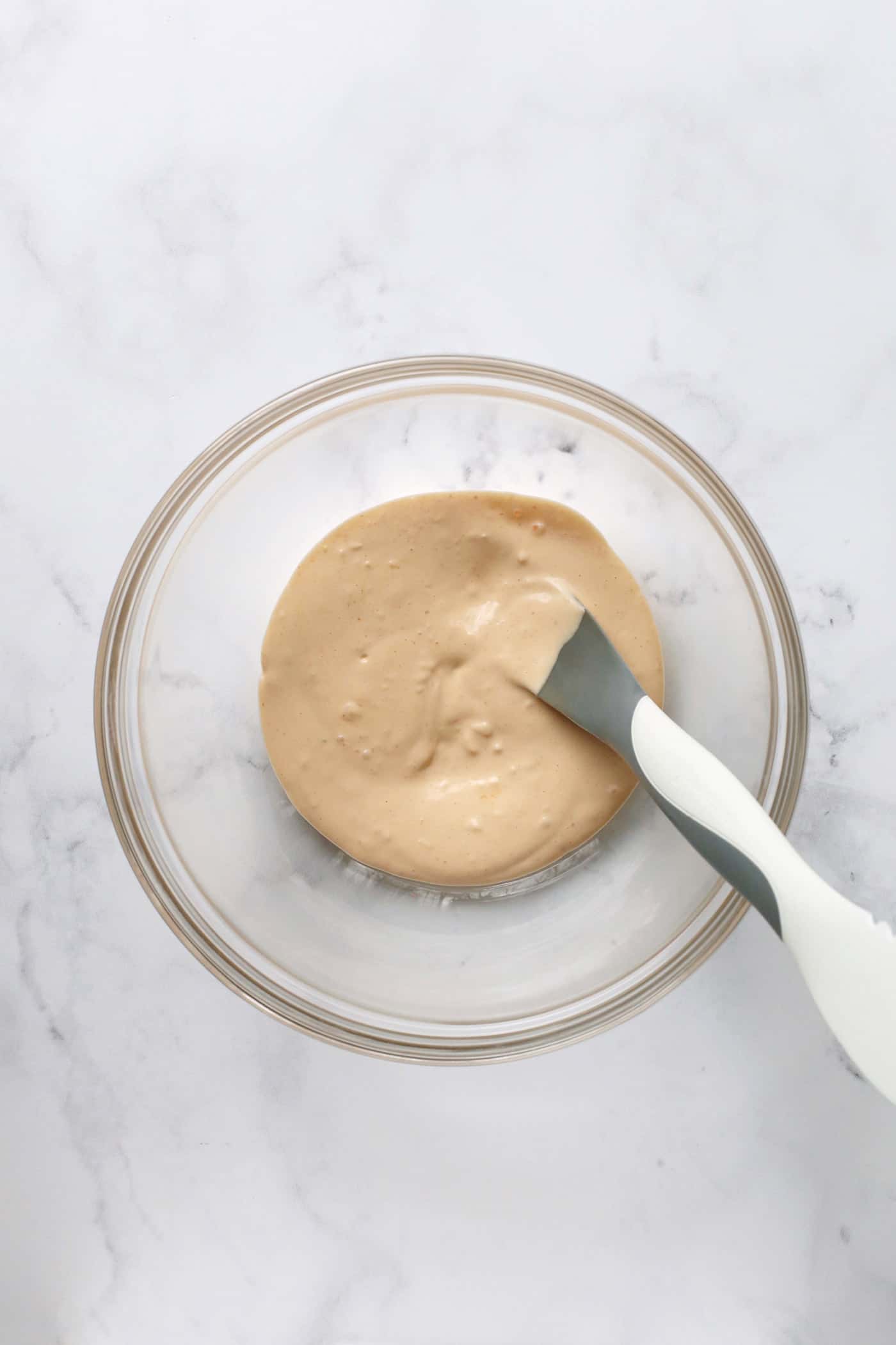 Sriracha mayo in a small glass dish.