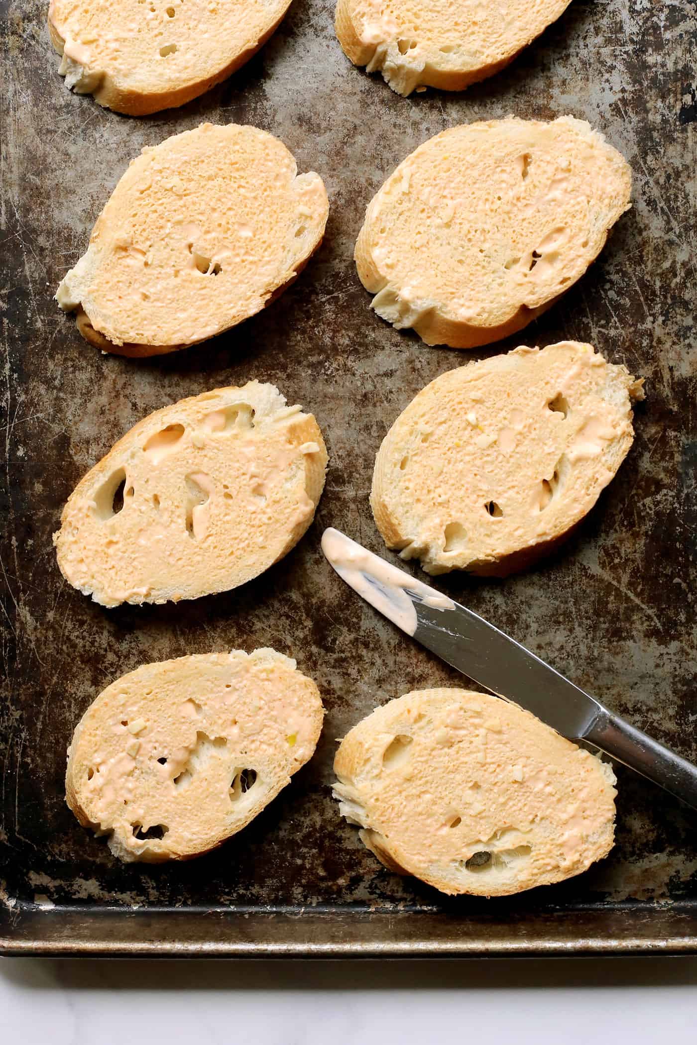 Slices of bread topped with sriracha mayo.