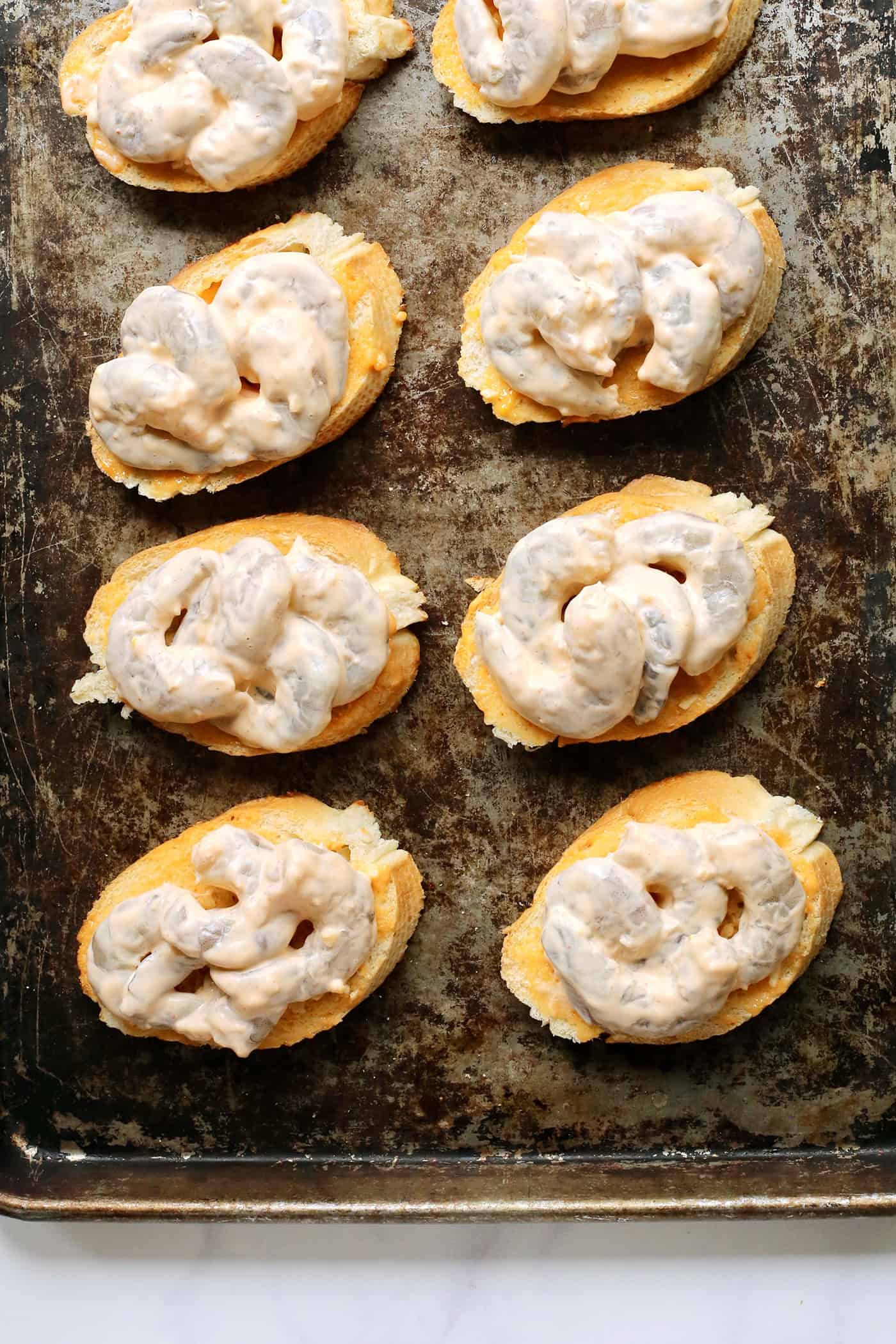 Shrimp toast on a baking sheet.