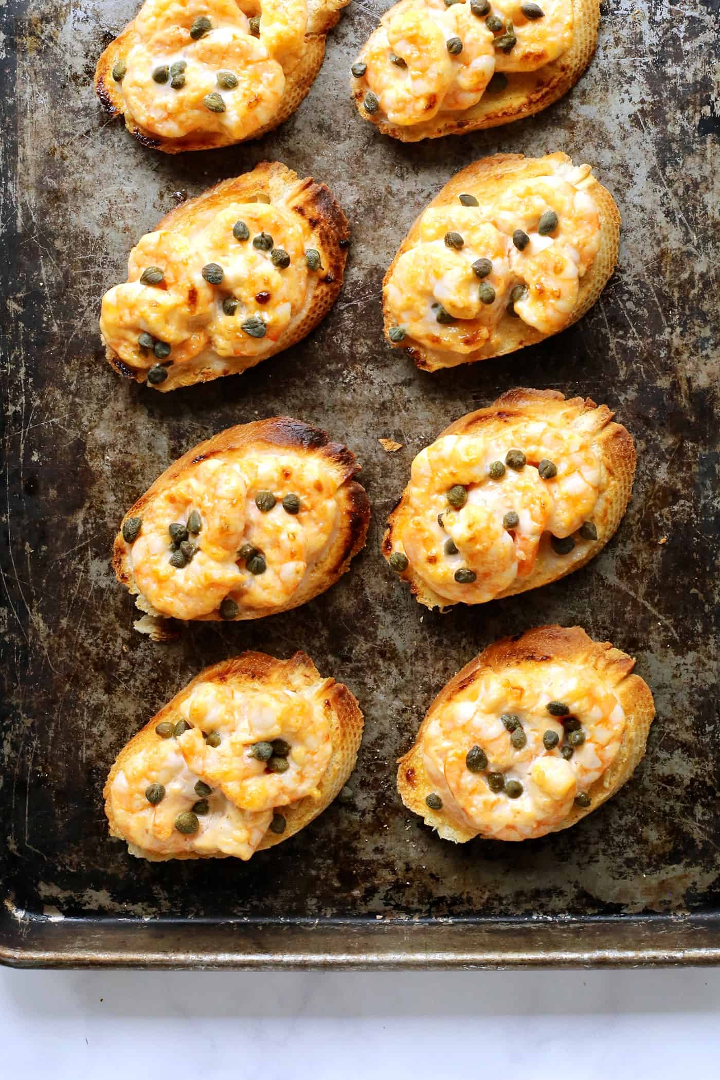 Sriracha shrimp toast on a baking sheet.