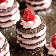 This easy raspberry dessert is filled with raspberry cream in between chocolate sandwich cookies an topped with a fresh raspberry.