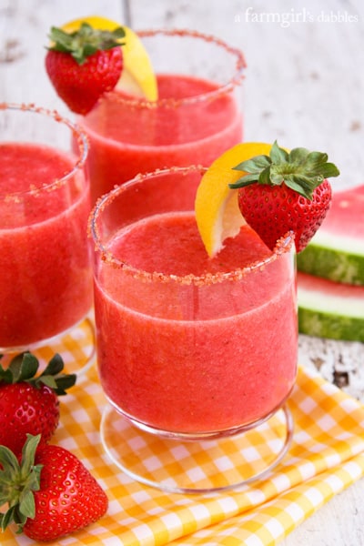 Frozen Strawberry Watermelon Lemonade in cocktail glasses with strawberry sugar on the rims