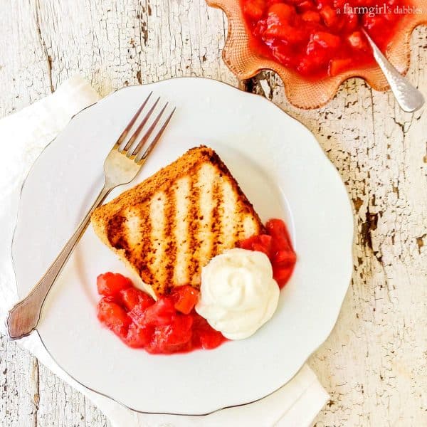 rhubarb sauce on a piece of Grilled Angel Food Cake