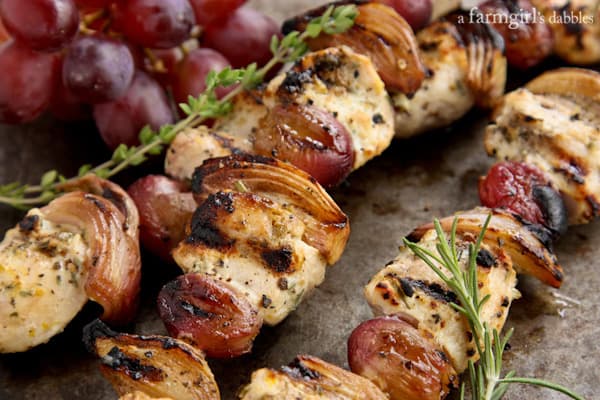grapes, chicken, and shallots on kebabs