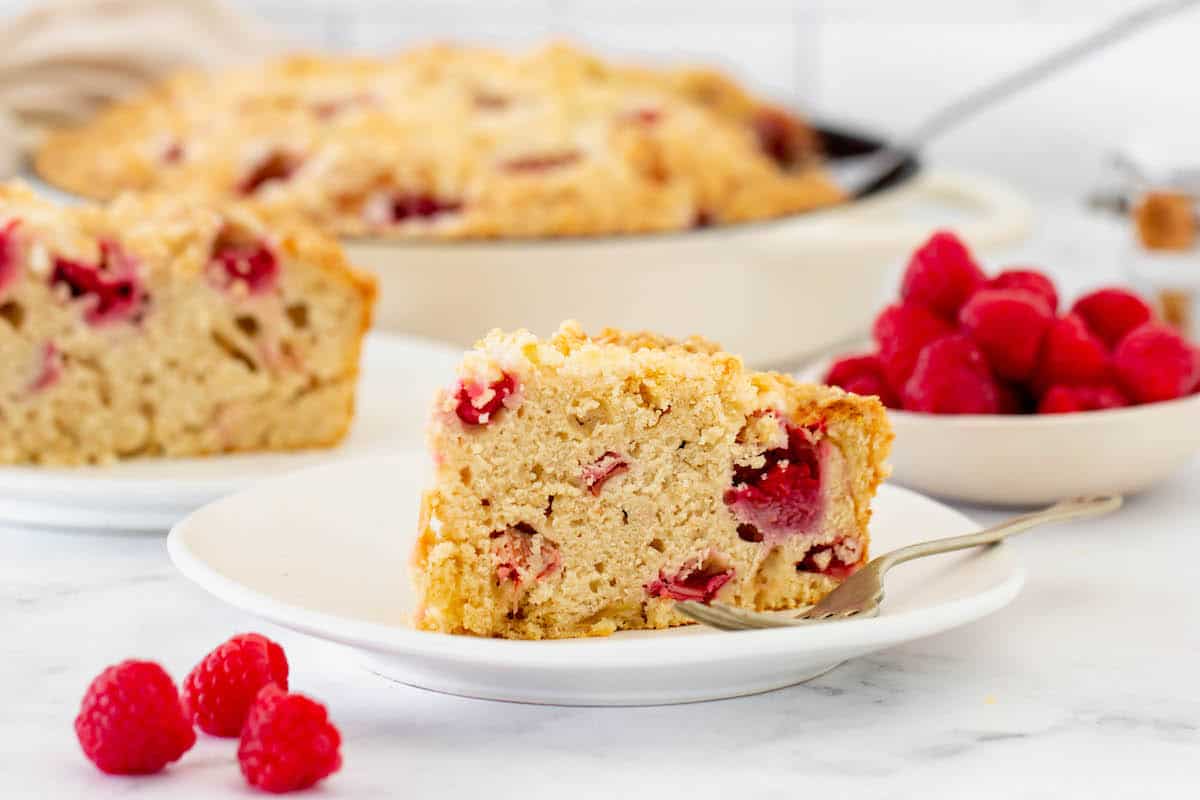 Two slices of raspberry rhubarb coffee cake on white plates