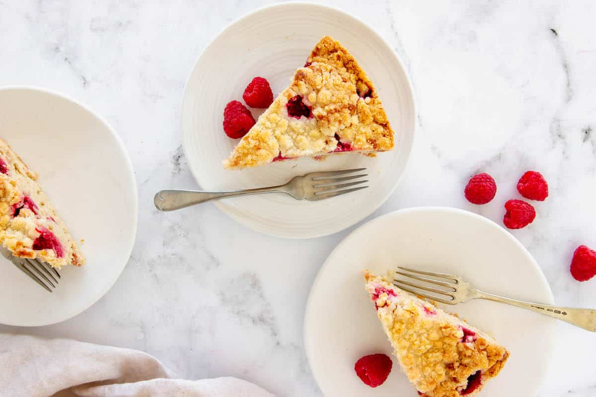 3 slices of raspberry rhubarb coffee cake on white plates