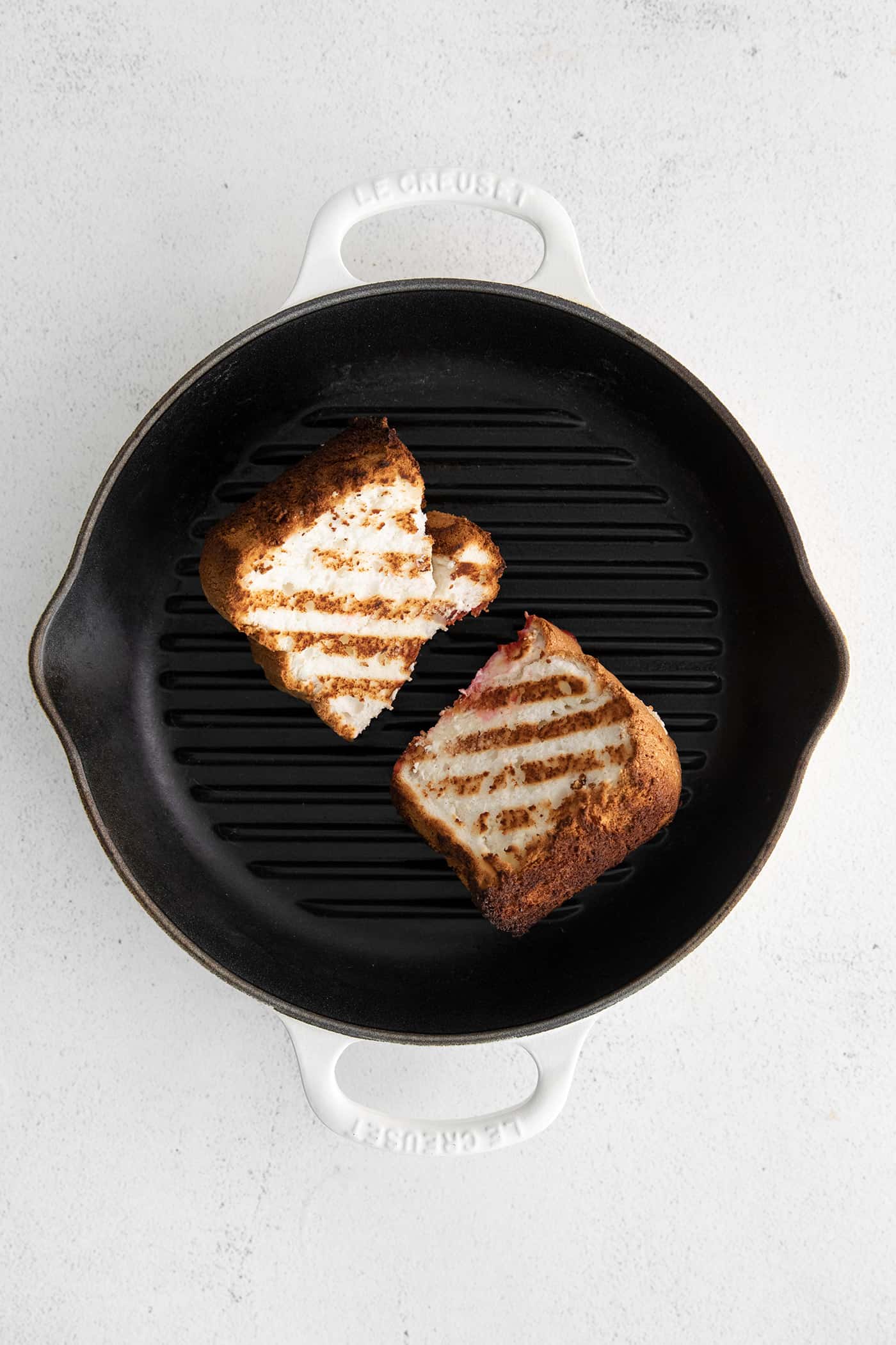 Two slices of angel food cake on a grill pan