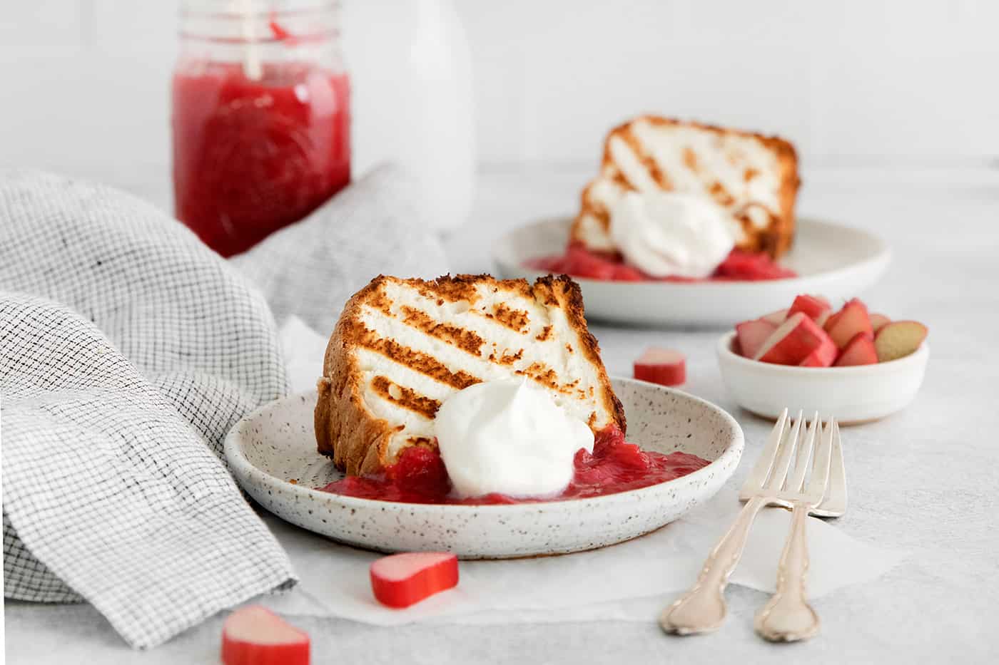Grilled angel food cake with rhubarb sauce and whipped cream