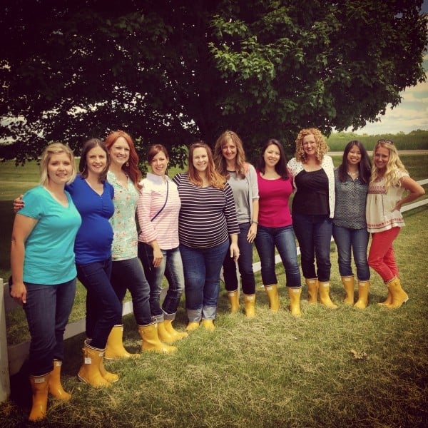 a group of women in yellow rain boots