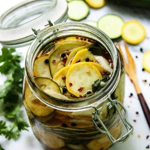 slices of pickled squash in a jar