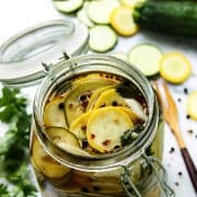 Homemade pickled squash recipe with peppercorns, coriander seeds, onions, and tangy brine.