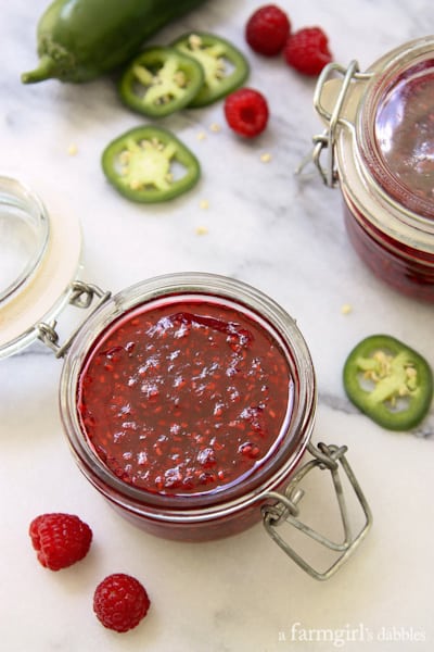 Raspberry Jalapeno Freezer Jam with fresh raspberries and sliced jalapeños