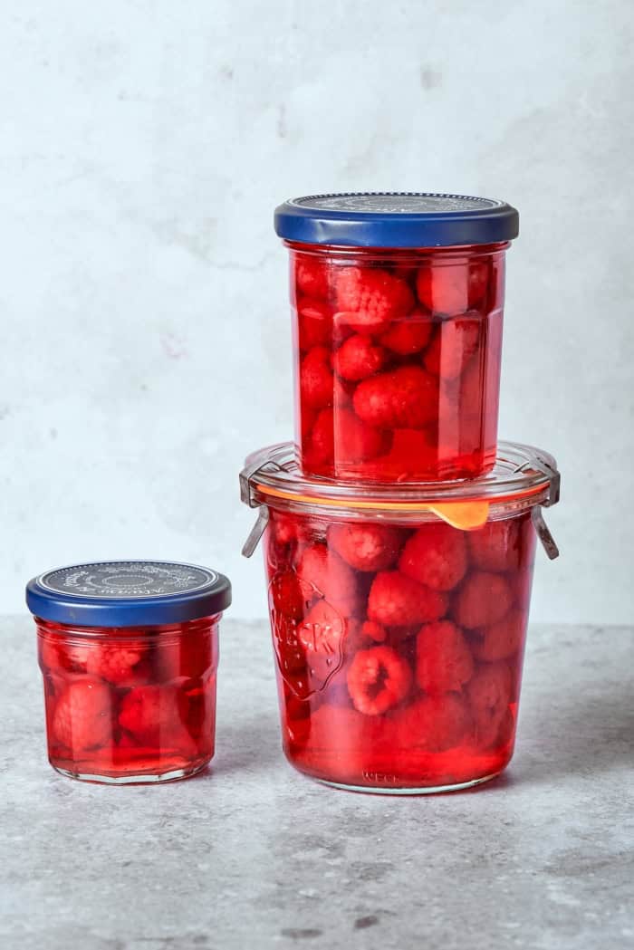 Made with just 3 simple ingredients, this homemade raspberry vinegar recipe is incredibly easy and fantastic for dressings, drinks and more! Raspberries infusing in jars of vinegar.