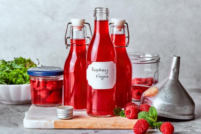 Made with just 3 simple ingredients, this homemade raspberry vinegar recipe is incredibly easy and fantastic for dressings, drinks and more! 3 bottles of homemade raspberry vinegar.