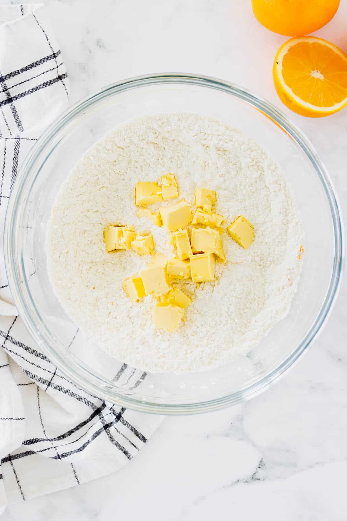 Cold butter being in a bowl of flour