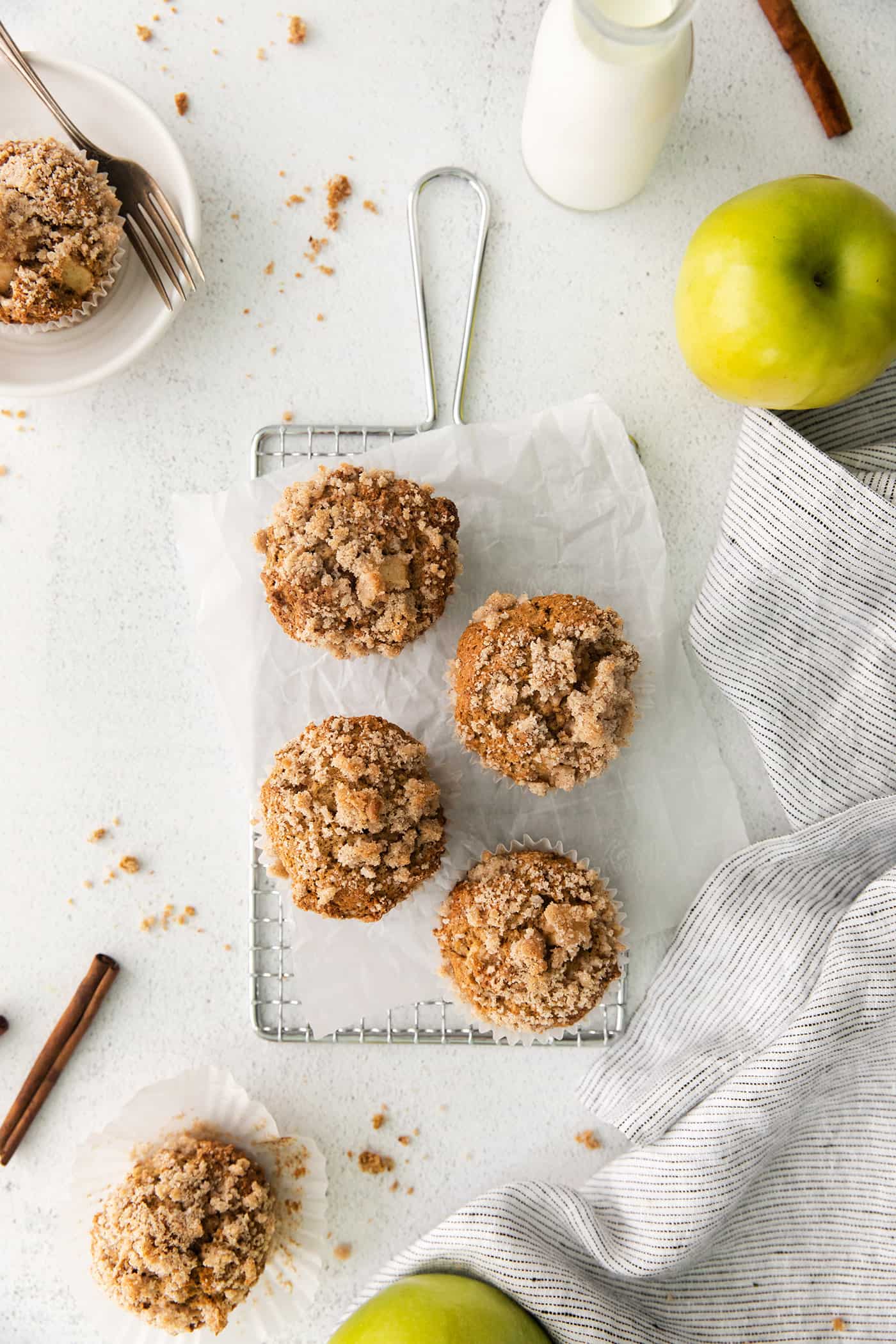 Overhead view of 4 apple muffins with cinnamon sugar crumble topping