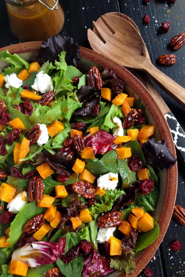 Harvest salad with butternut squash in a wooden bowl