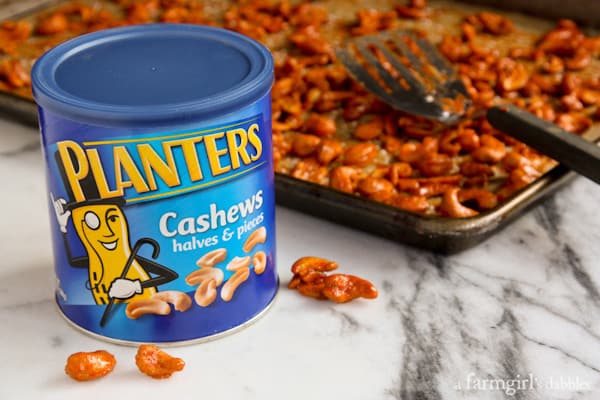 planters cashews and a pan of Candied Sriracha Cashews