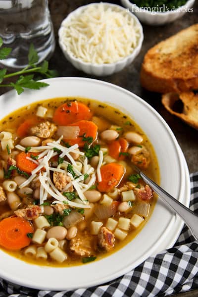 Chicken Sausage Soup with pieces of toast and cheese