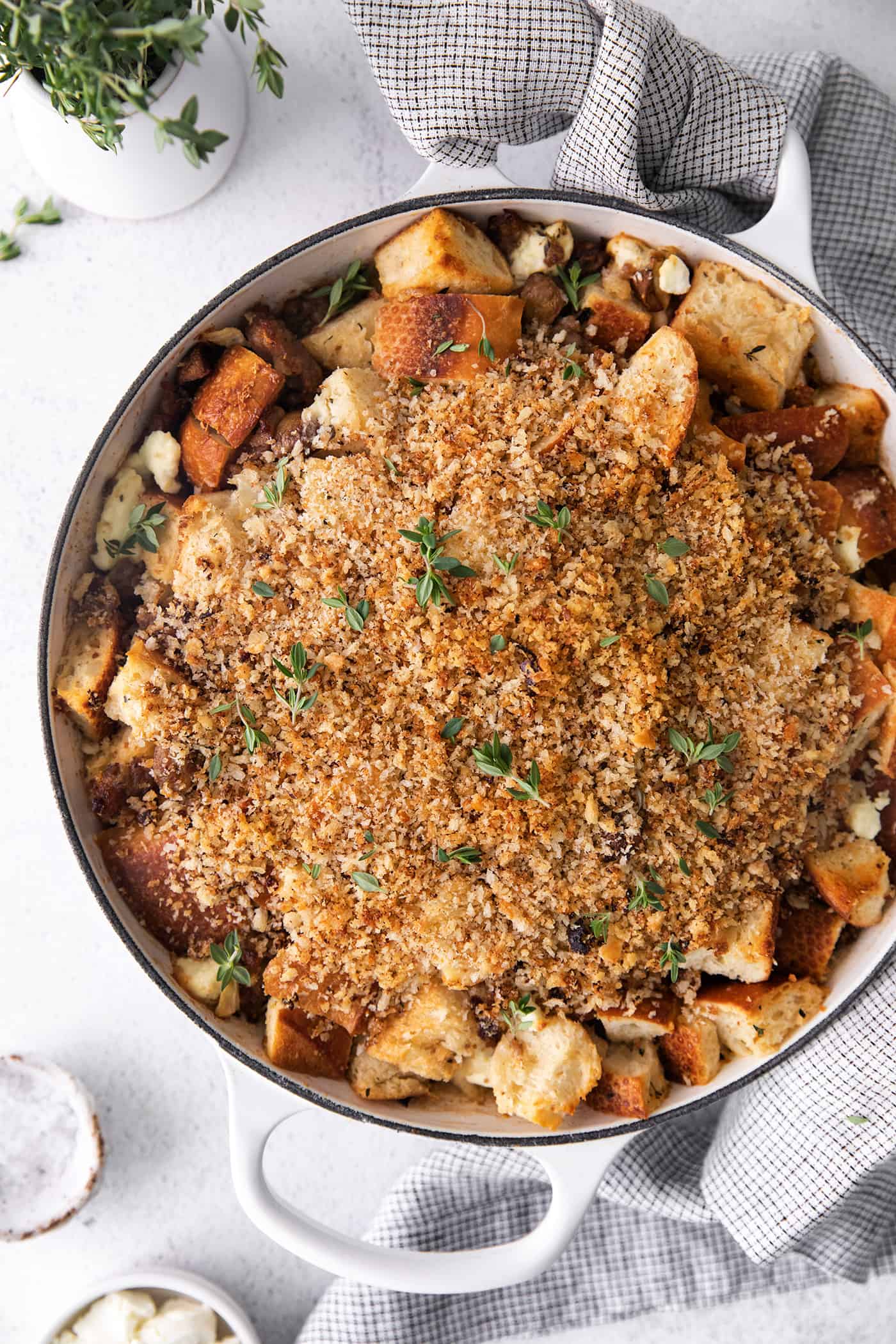 A white casserole dish of roasted garlic mushroom dressing