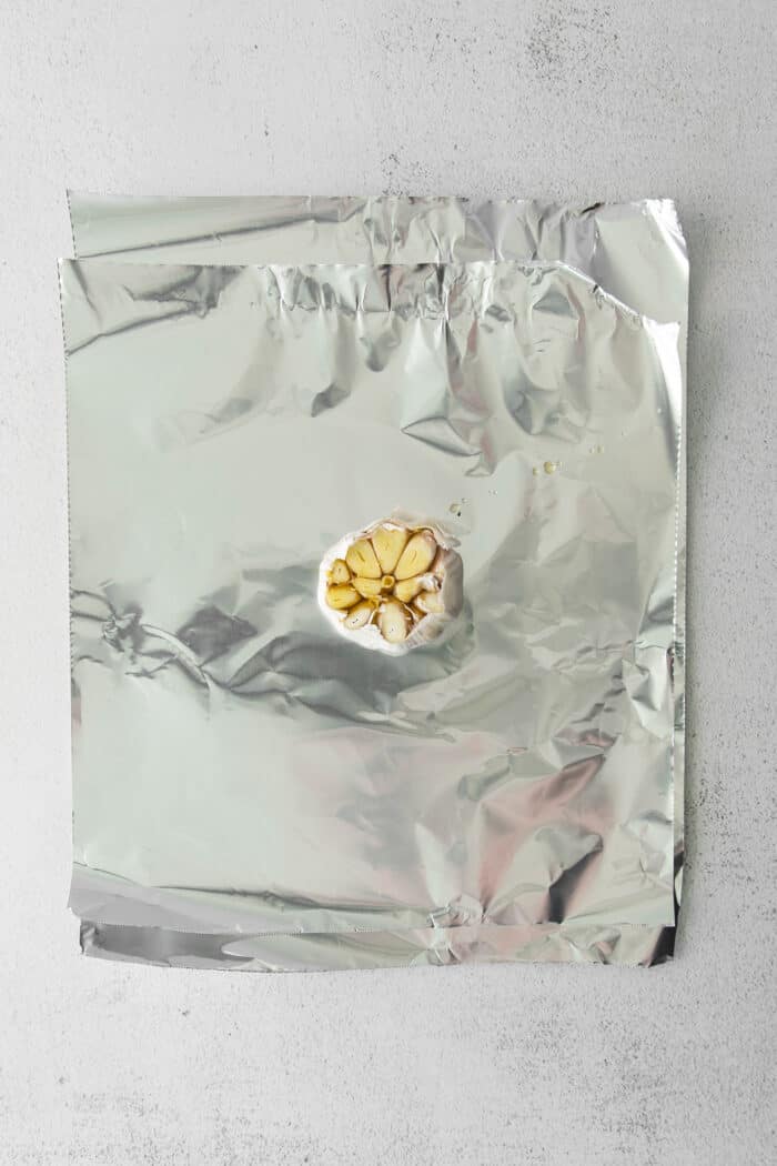 A head of fresh garlic on foil