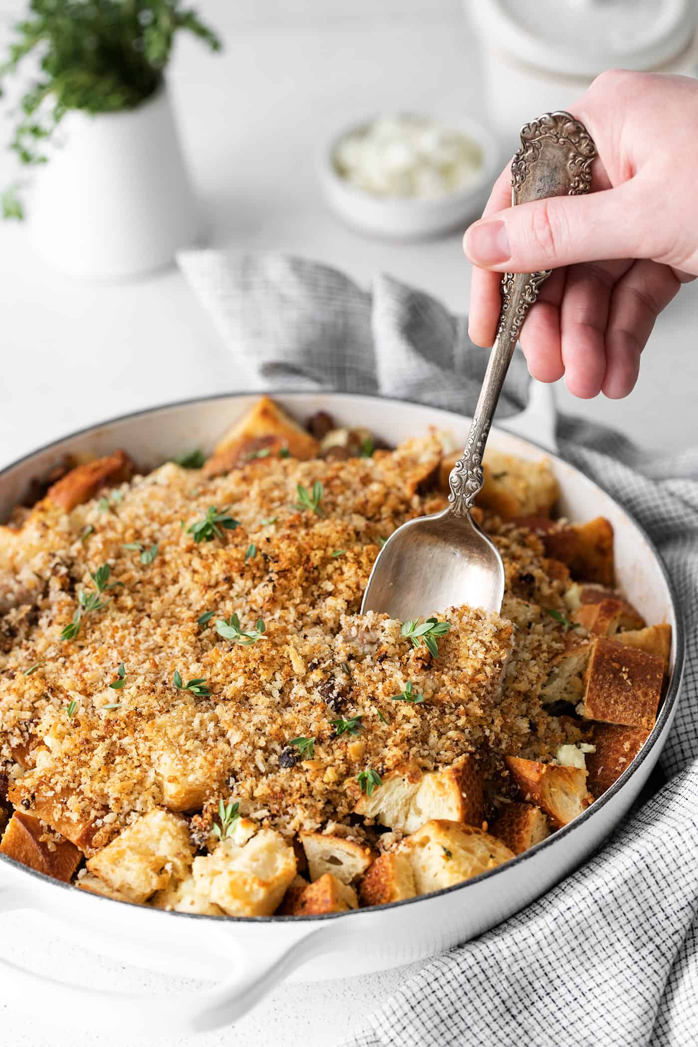 A spoon serving roasted garlic mushroom dressing