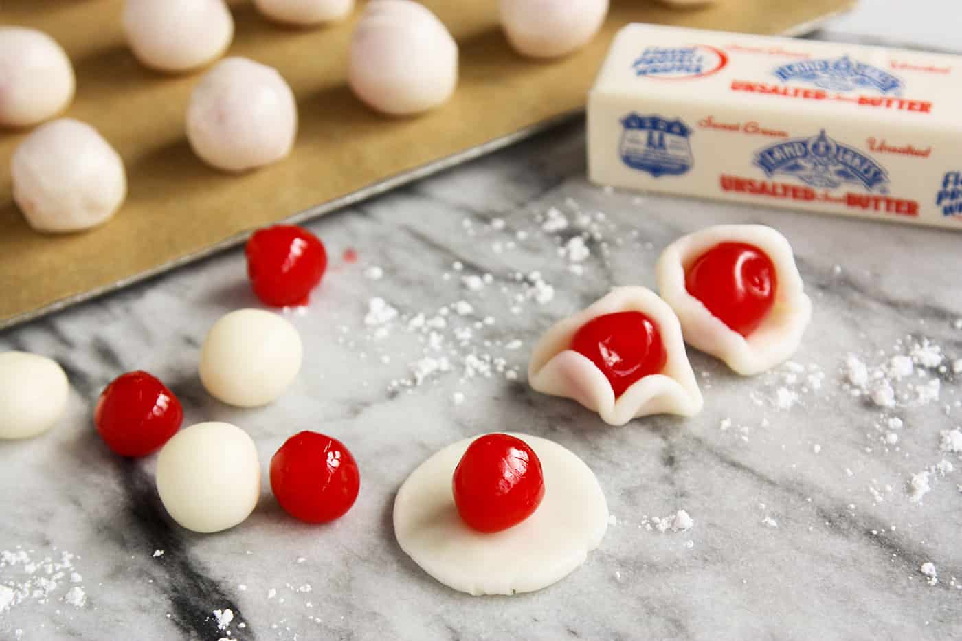 Maraschino cherries being wrapped in dough