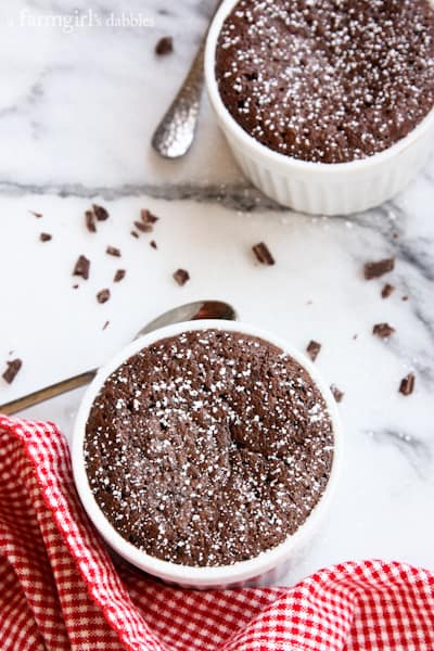 Chocolate Cake in white ramekins and dusted with powdered sugar