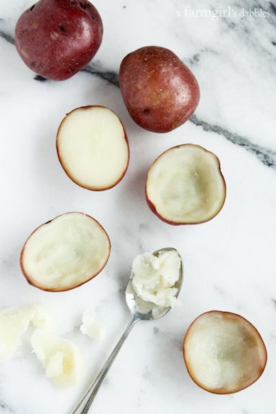 potatoes cut in half with the insides scooped out