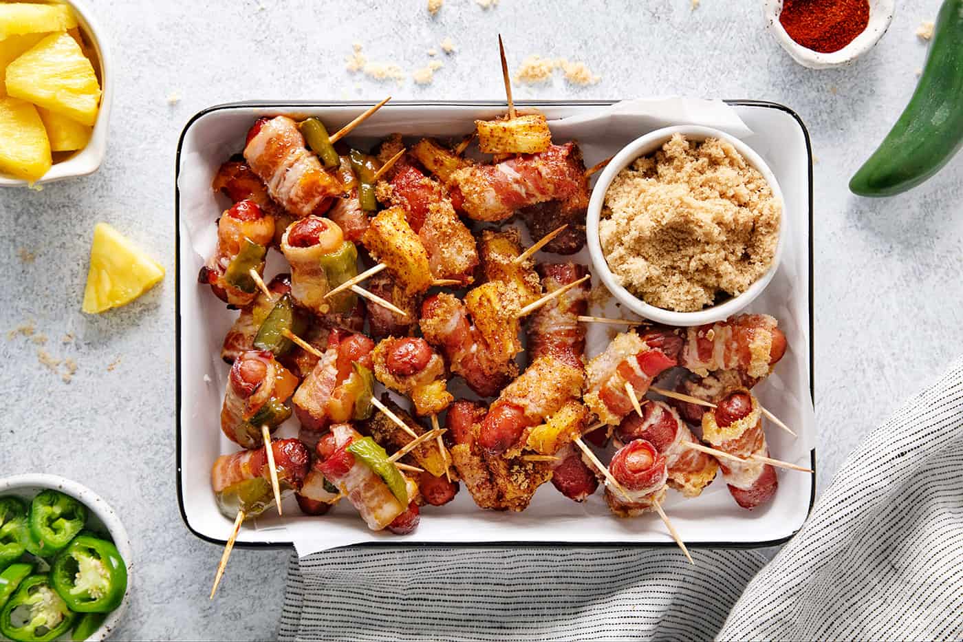 Overhead view of a tray of bacon wrapped smokies